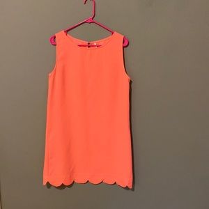 Coral scalloped hemmed dress.